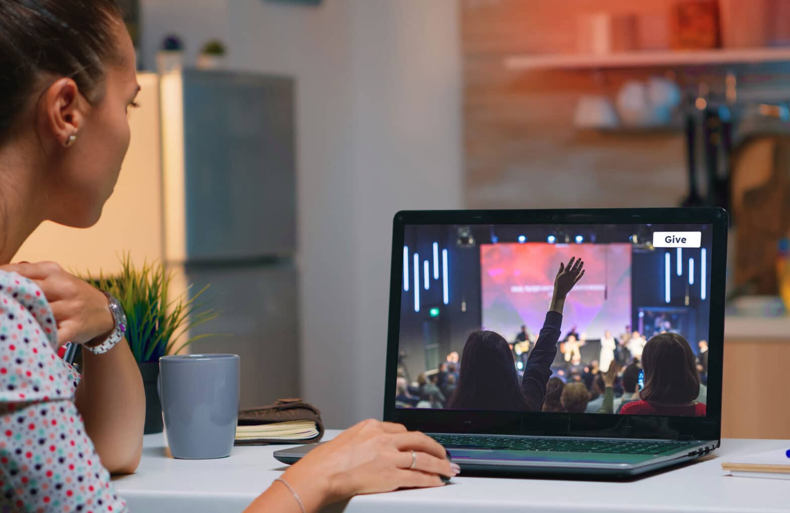 Woman livestreaming church service from laptop